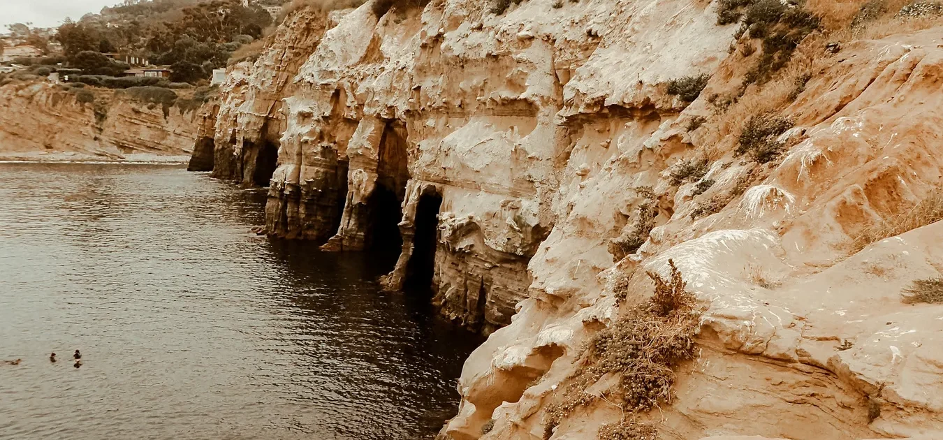 Sandstone cliffs meeting the water at La Jolla Cove, San Diego